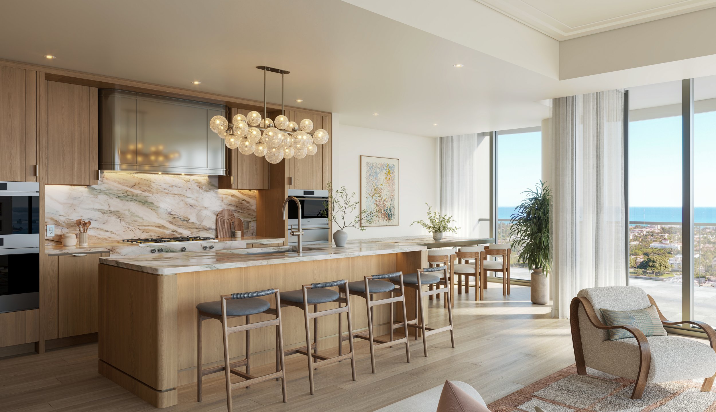 Modern open-concept kitchen and dining area with marble countertops and ocean views at Edgeworth West Palm Beach