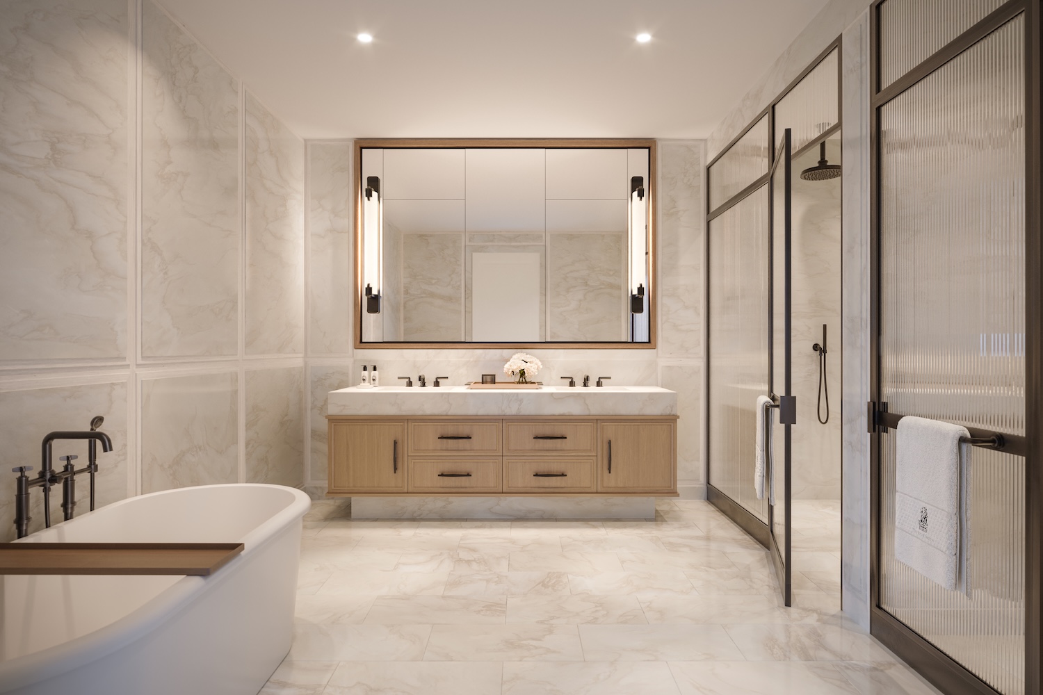 Primary bathroom with marble walls, freestanding soaking tub, and Waterworks fixtures at The Ritz-Carlton Residences Fort Lauderdale Beach
